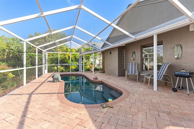 pool with a patio area and glass enclosure