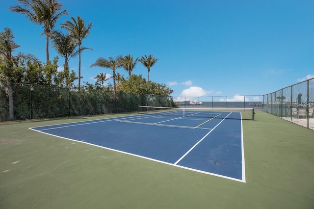 view of tennis court featuring fence