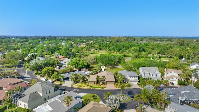 drone / aerial view with a residential view and a view of trees