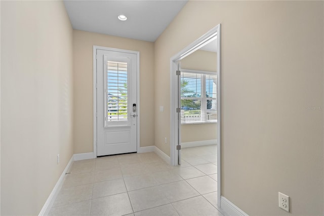 entryway featuring light tile patterned flooring and baseboards