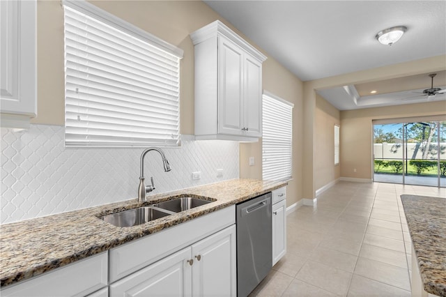 kitchen featuring a sink, backsplash, white cabinets, light tile patterned floors, and dishwasher