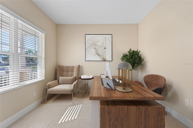 office space with light tile patterned floors and baseboards