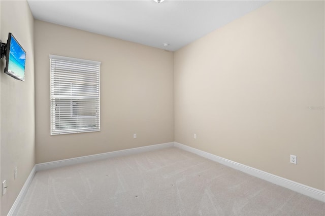 empty room with carpet and baseboards