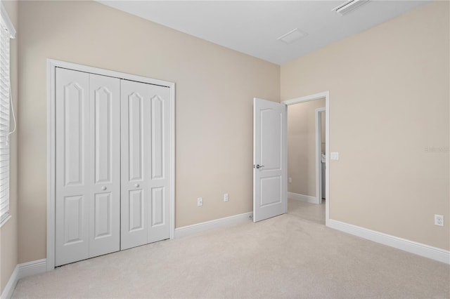 unfurnished bedroom featuring visible vents, baseboards, carpet, and a closet