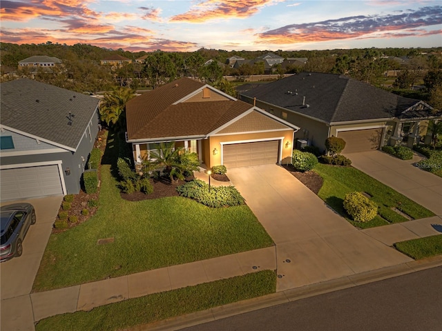 single story home with a front lawn, a garage, and driveway