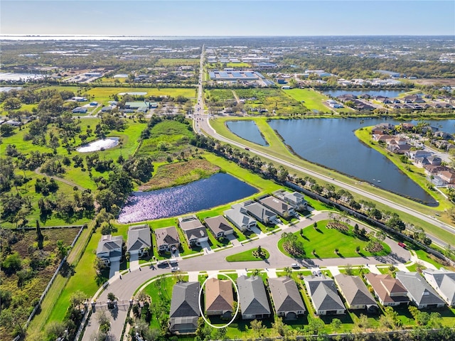 birds eye view of property featuring a residential view and a water view
