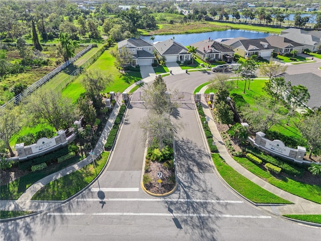 drone / aerial view with a residential view and a water view