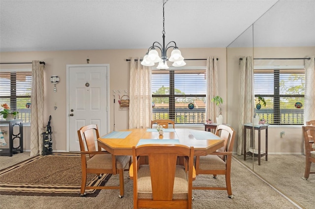 dining space with baseboards, a chandelier, and light carpet