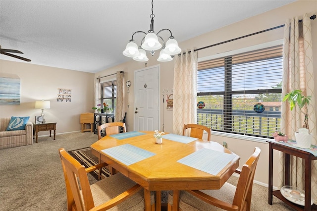 carpeted dining area featuring baseboards and a ceiling fan