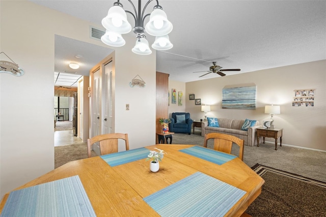 carpeted dining room featuring visible vents and a ceiling fan