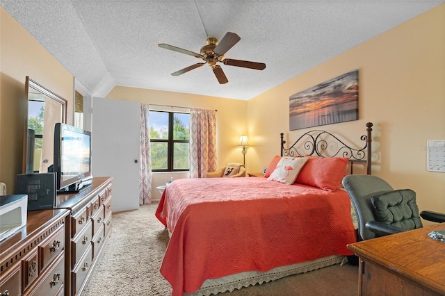 bedroom with light carpet, a textured ceiling, and a ceiling fan