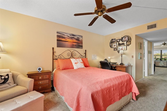 carpeted bedroom with visible vents and ceiling fan