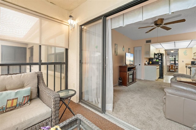 balcony featuring a ceiling fan, visible vents, and a sunroom