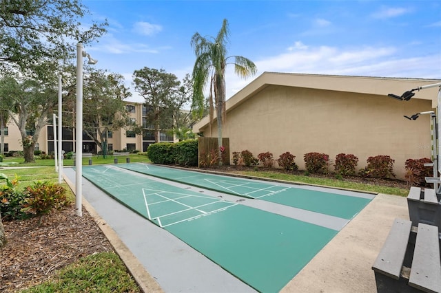 view of property's community featuring shuffleboard