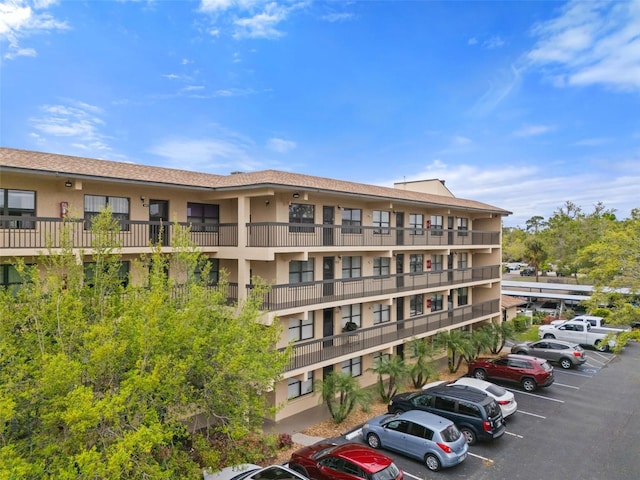 view of property featuring uncovered parking