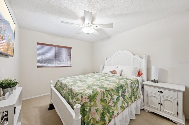 bedroom with baseboards, light colored carpet, ceiling fan, and a textured ceiling