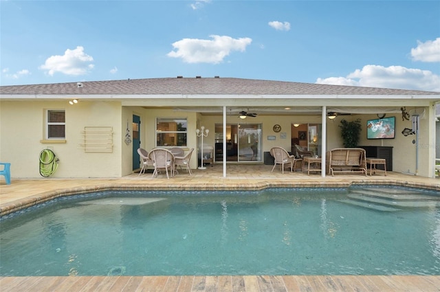 outdoor pool featuring ceiling fan and a patio