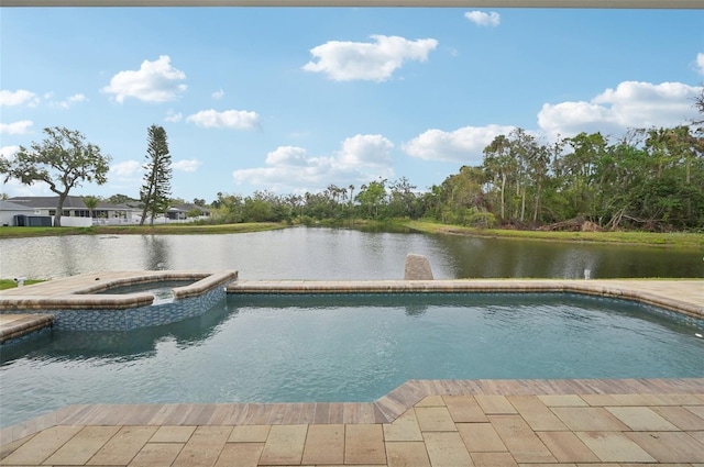 view of pool with a pool with connected hot tub and a water view