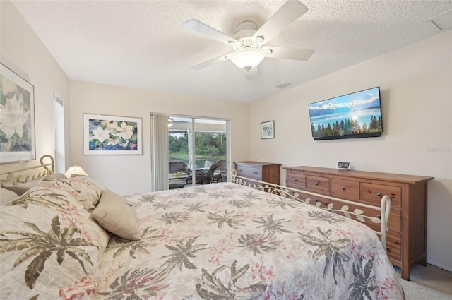 bedroom featuring visible vents, access to exterior, a textured ceiling, carpet, and ceiling fan