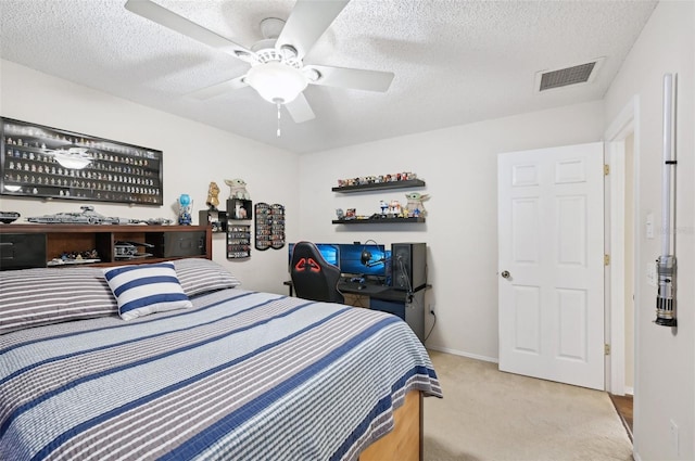 carpeted bedroom with visible vents, baseboards, a textured ceiling, and ceiling fan