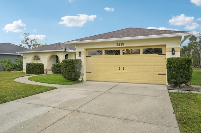 view of front of property with a shingled roof, a front lawn, stucco siding, a garage, and driveway