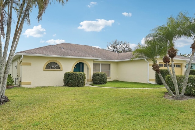 single story home featuring stucco siding, a front yard, an attached garage, and a shingled roof