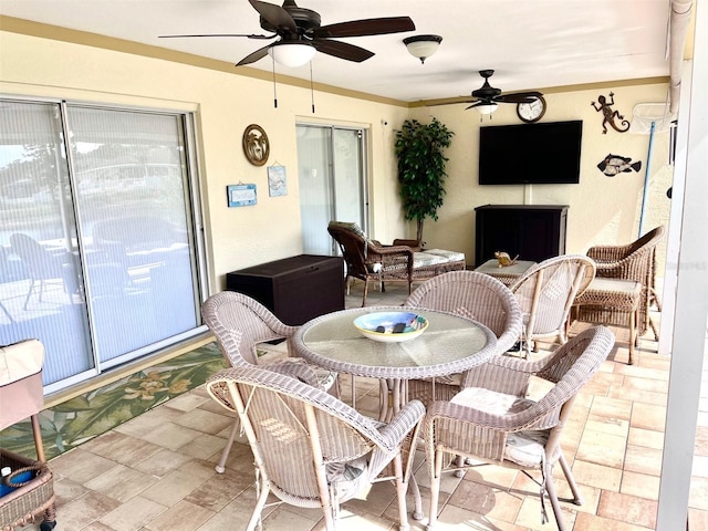 dining space with crown molding and a ceiling fan