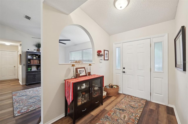 3419 31st St E, Bradenton, FL 34208 - entrance foyer with wood finished floors, arched walkways, a textured ceiling, baseboards, and ceiling fan