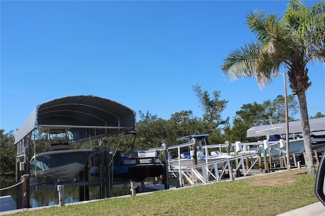 dock area with a lawn and boat lift