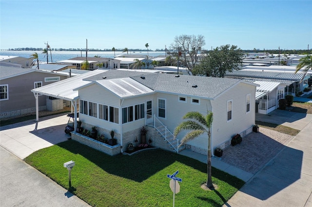 drone / aerial view with a residential view and a water view