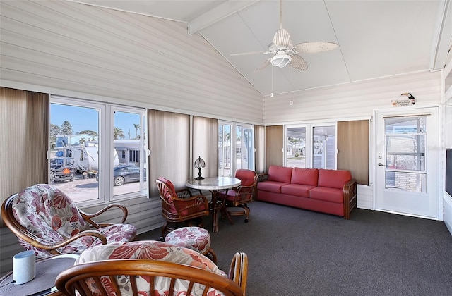 sunroom / solarium with plenty of natural light, vaulted ceiling with beams, and a ceiling fan