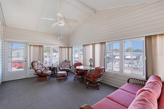 sunroom with vaulted ceiling with beams and a ceiling fan