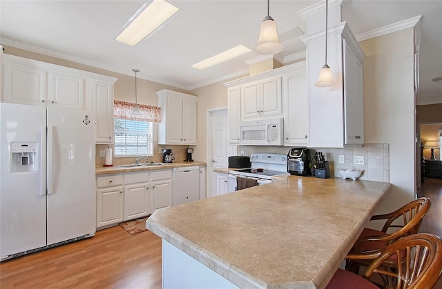 kitchen featuring a sink, white appliances, white cabinets, and light countertops