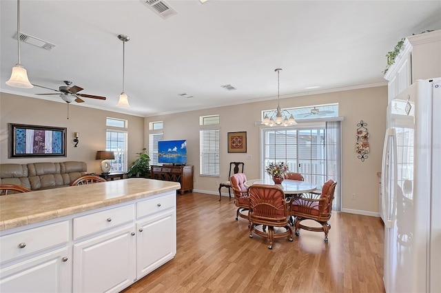 kitchen with light wood-type flooring, visible vents, open floor plan, and freestanding refrigerator