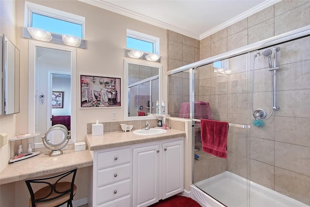 bathroom with vanity, crown molding, and a stall shower