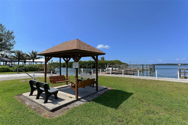 exterior space featuring a gazebo, a dock, and a water view