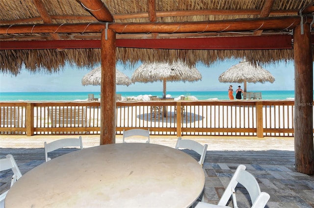 view of patio / terrace with a gazebo, a deck with water view, and outdoor dining area