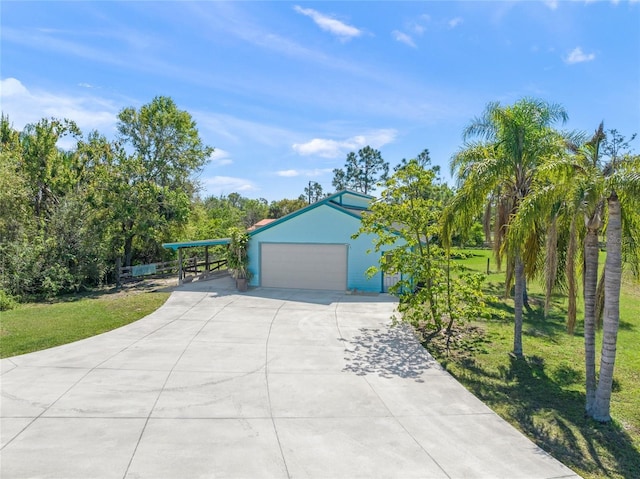 garage featuring a carport and driveway