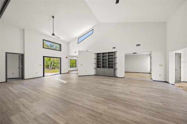 unfurnished living room featuring a ceiling fan, visible vents, baseboards, vaulted ceiling, and light wood-style floors