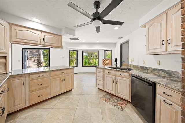 kitchen with light brown cabinets, dishwasher, and a peninsula