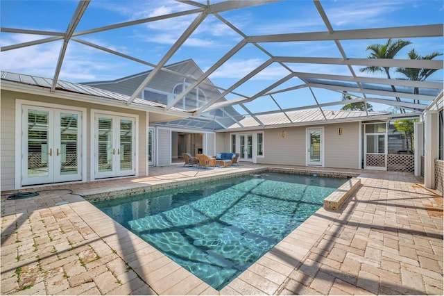 pool with french doors, a lanai, and a patio area