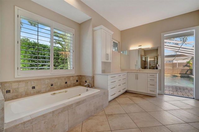 full bathroom featuring a shower stall, tile patterned floors, a bath, and vanity