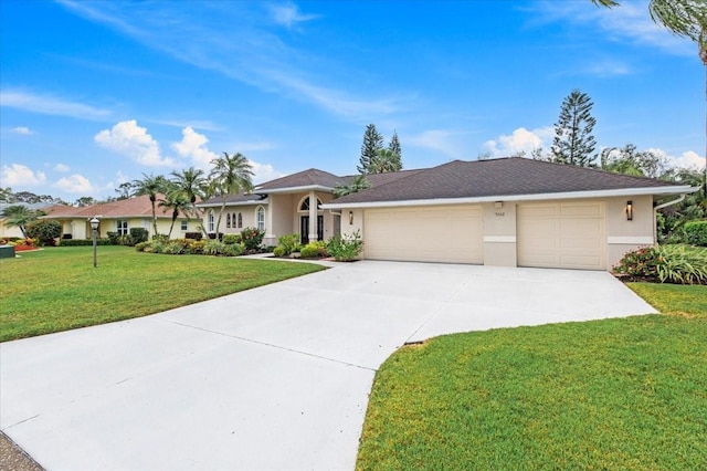 single story home with a front lawn, an attached garage, driveway, and stucco siding