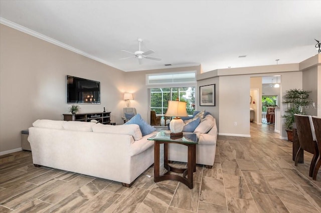 living room featuring ceiling fan, baseboards, and ornamental molding