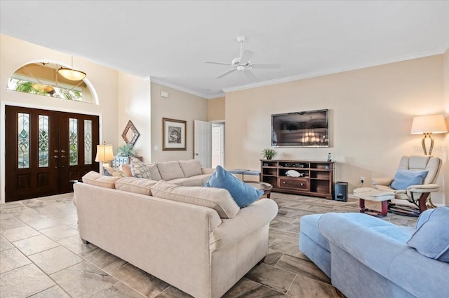 living area with a ceiling fan and ornamental molding