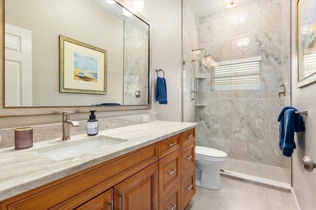 bathroom featuring toilet, walk in shower, and vanity