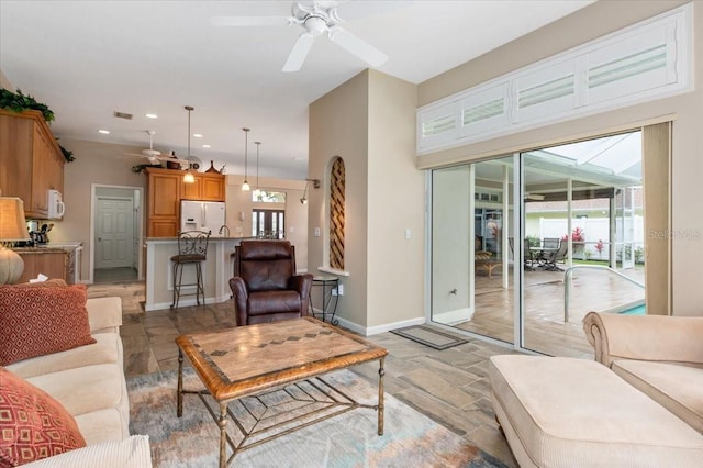 living room featuring recessed lighting, baseboards, plenty of natural light, and ceiling fan