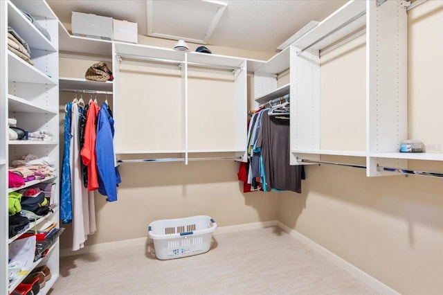 walk in closet featuring attic access