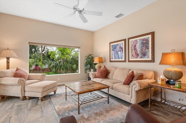 living room featuring visible vents, baseboards, and ceiling fan