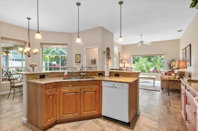 kitchen featuring open floor plan, dishwasher, an island with sink, brown cabinets, and a sink